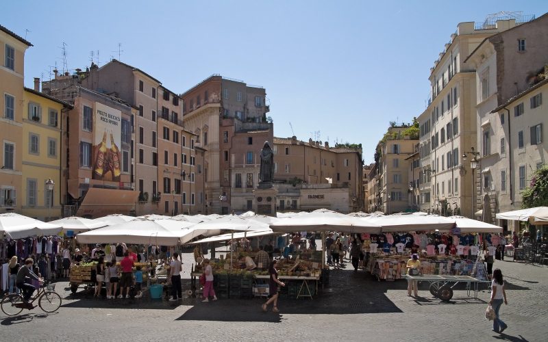 Market stalls under white umbrellas on Campo de' Fiori square in Rome