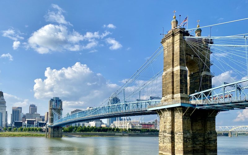 Roebling Suspension Bridge and the Cincinnati skyline under blue sky