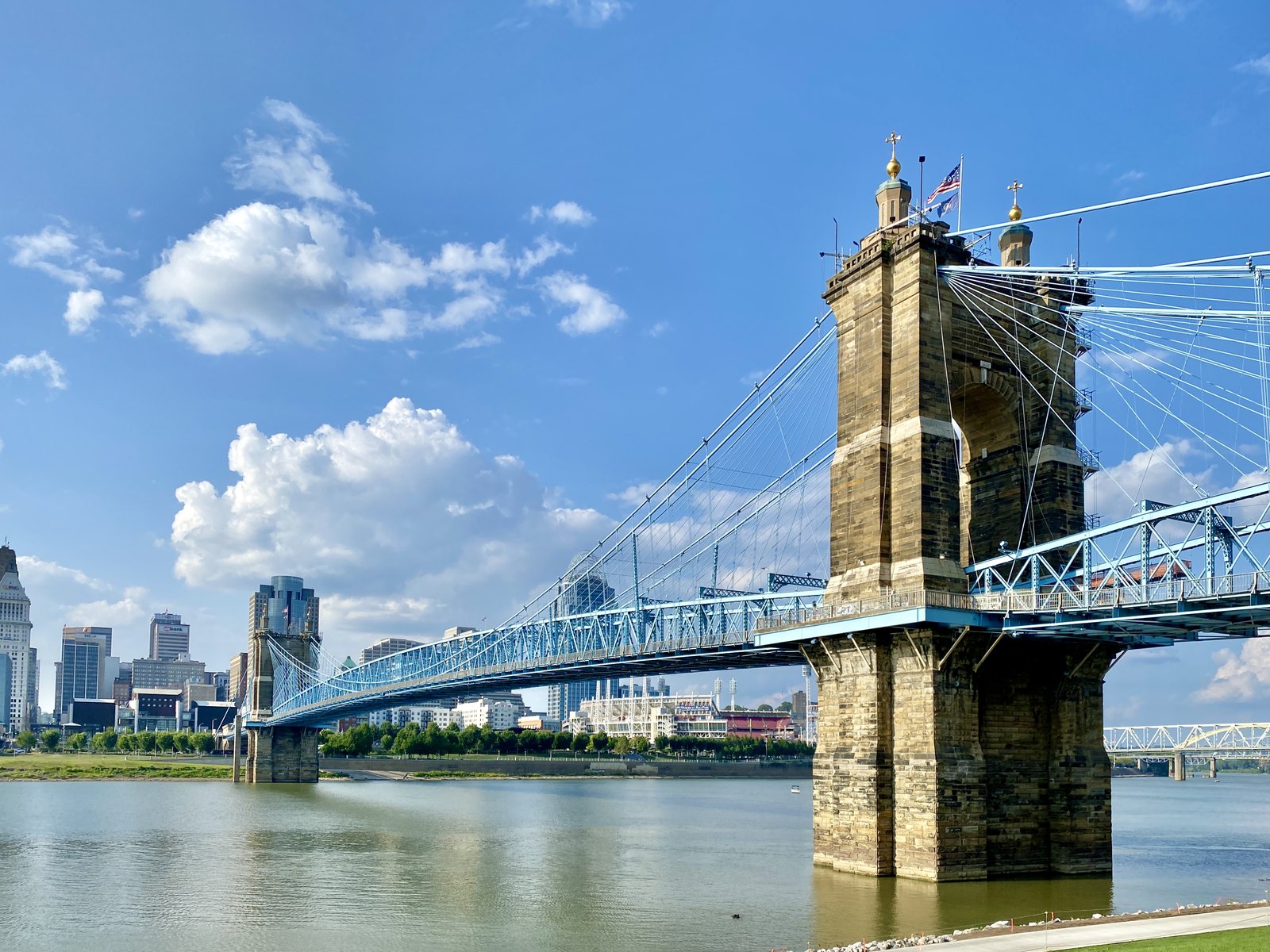 Roebling Suspension Bridge and the Cincinnati skyline under blue sky
