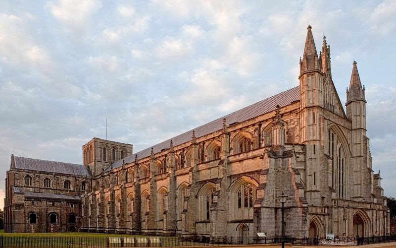 Winchester Cathedral nave seen from the side in warm evening light