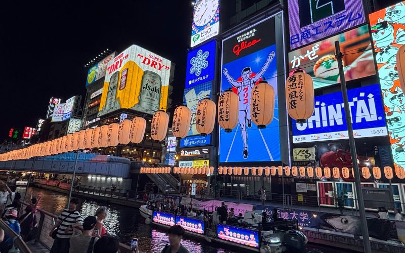 Neon signs and lanterns along the Dotonbori canal at night in Osaka