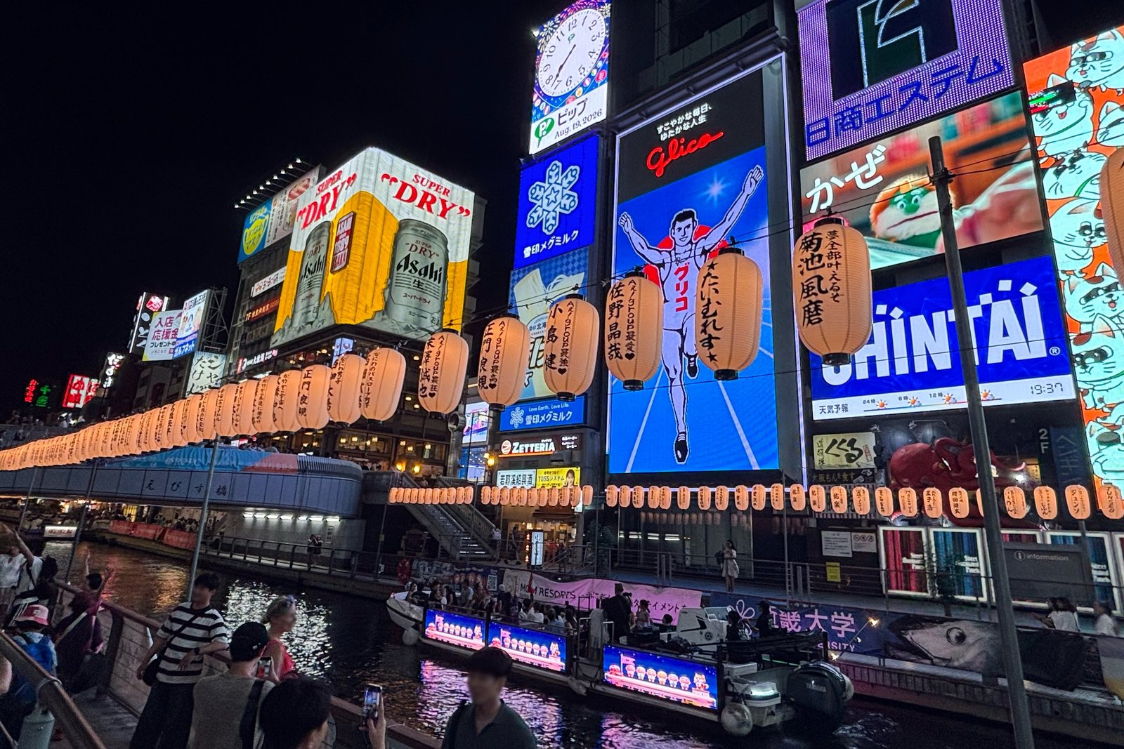 Neon signs and lanterns along the Dotonbori canal at night in Osaka