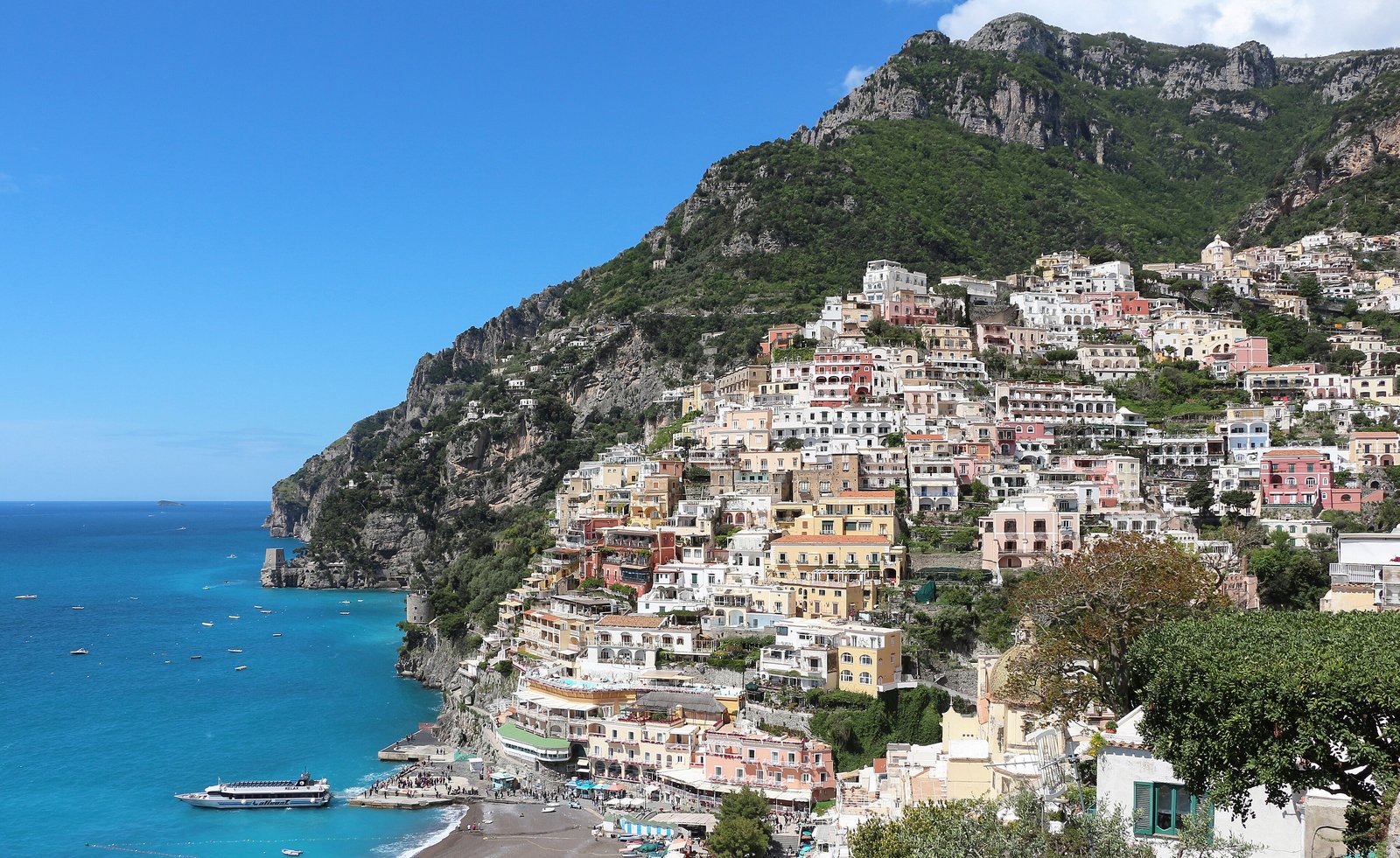 Pastel houses climbing the cliffs above the turquoise sea at Positano on the Amalfi Coast