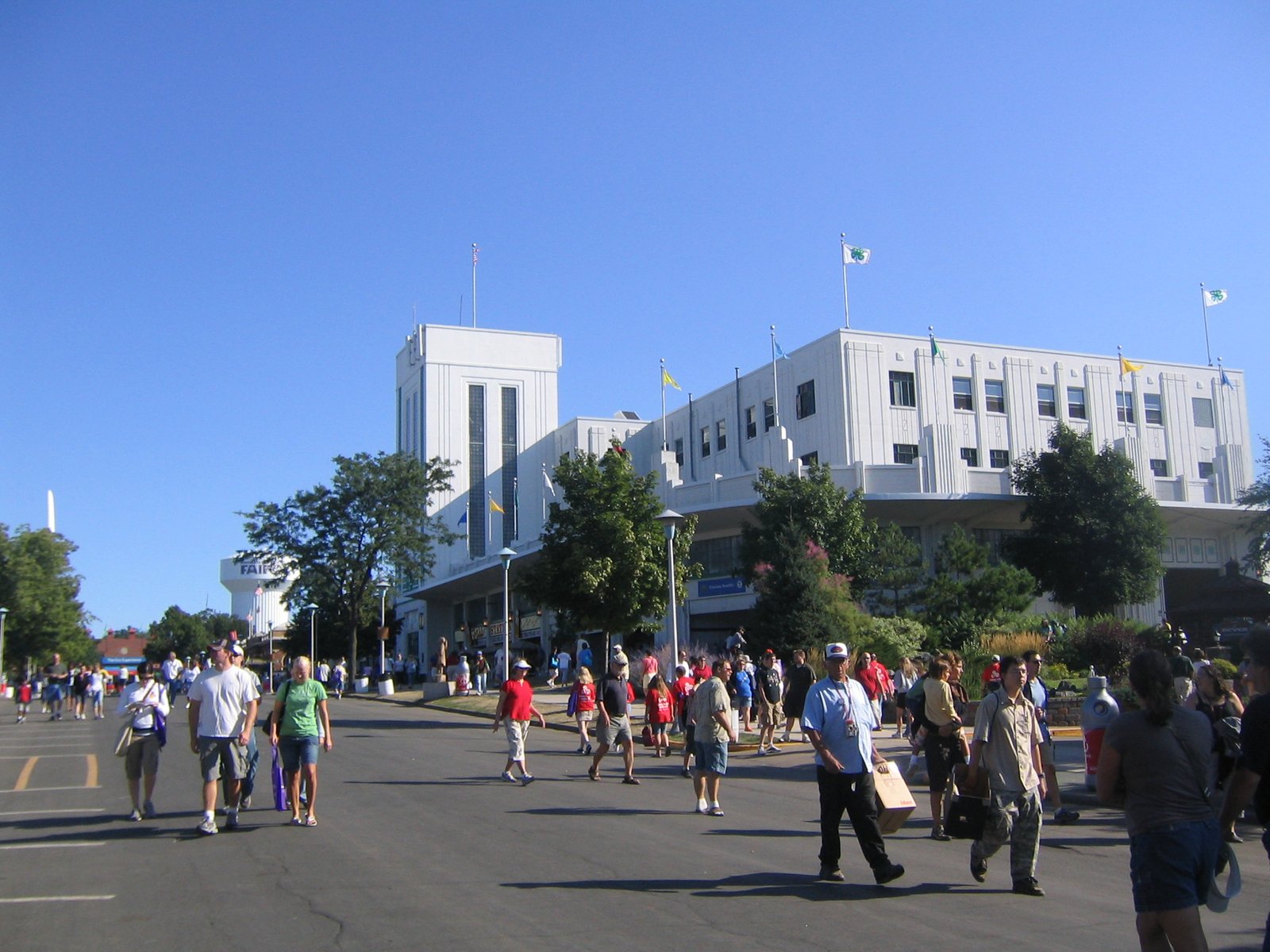 White exhibition building and visitors on an avenue of the Minnesota State Fair grounds