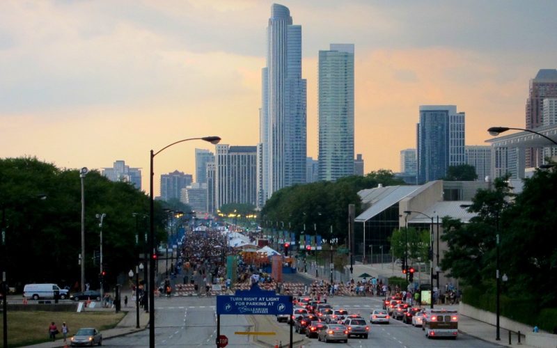 Crowd on the street at Taste of Chicago with the downtown skyline at dusk