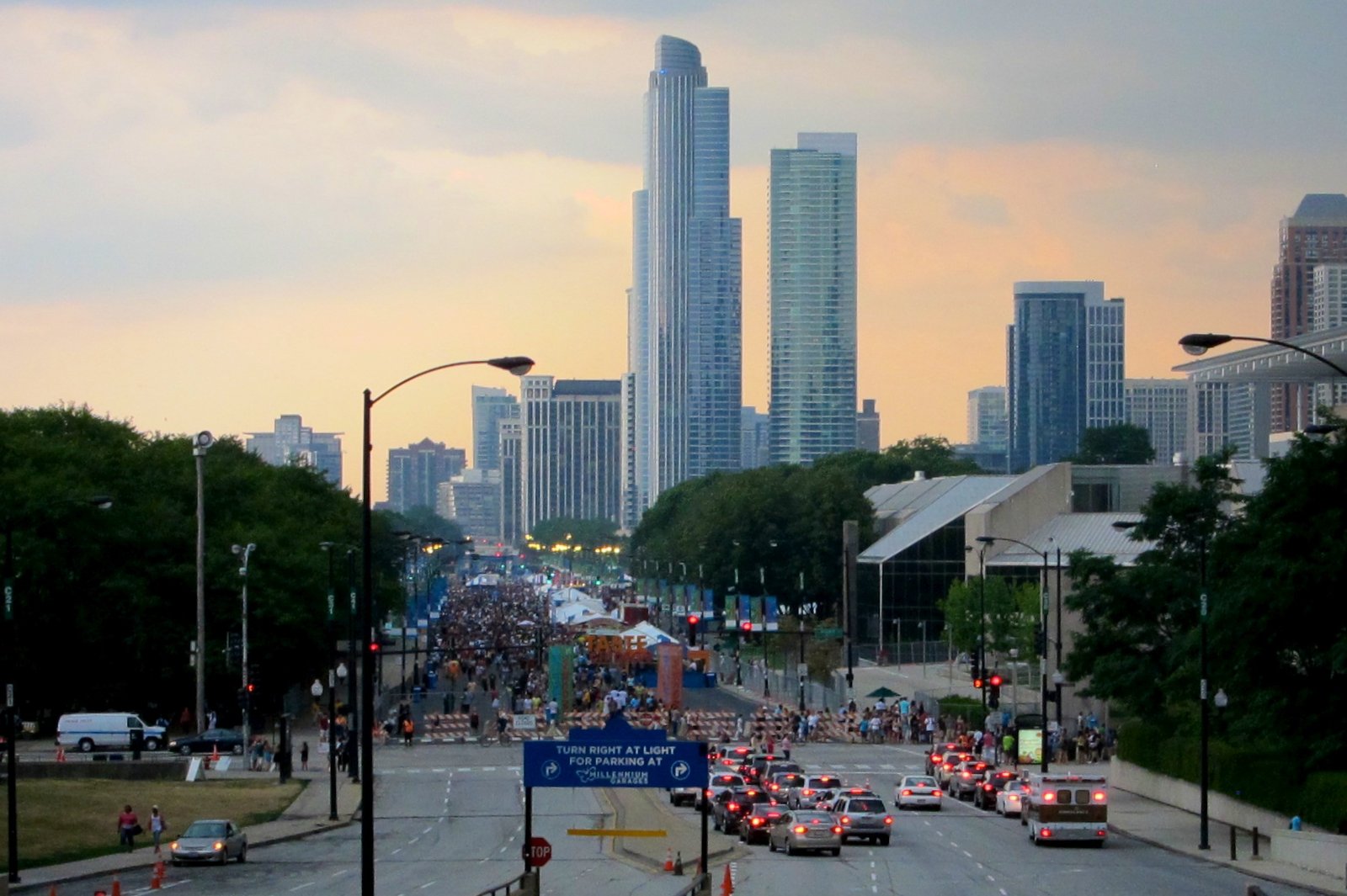 Crowd on the street at Taste of Chicago with the downtown skyline at dusk