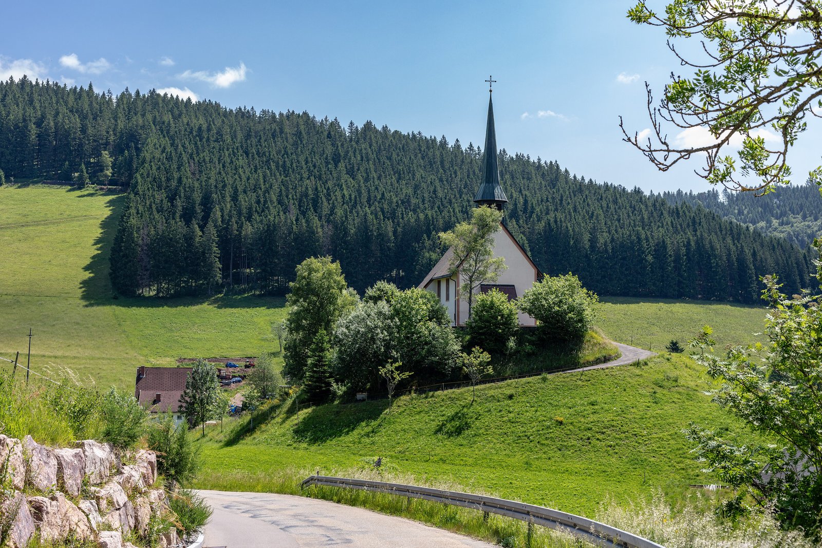 Small chapel among green meadows and fir forest in the Black Forest near Furtwangen