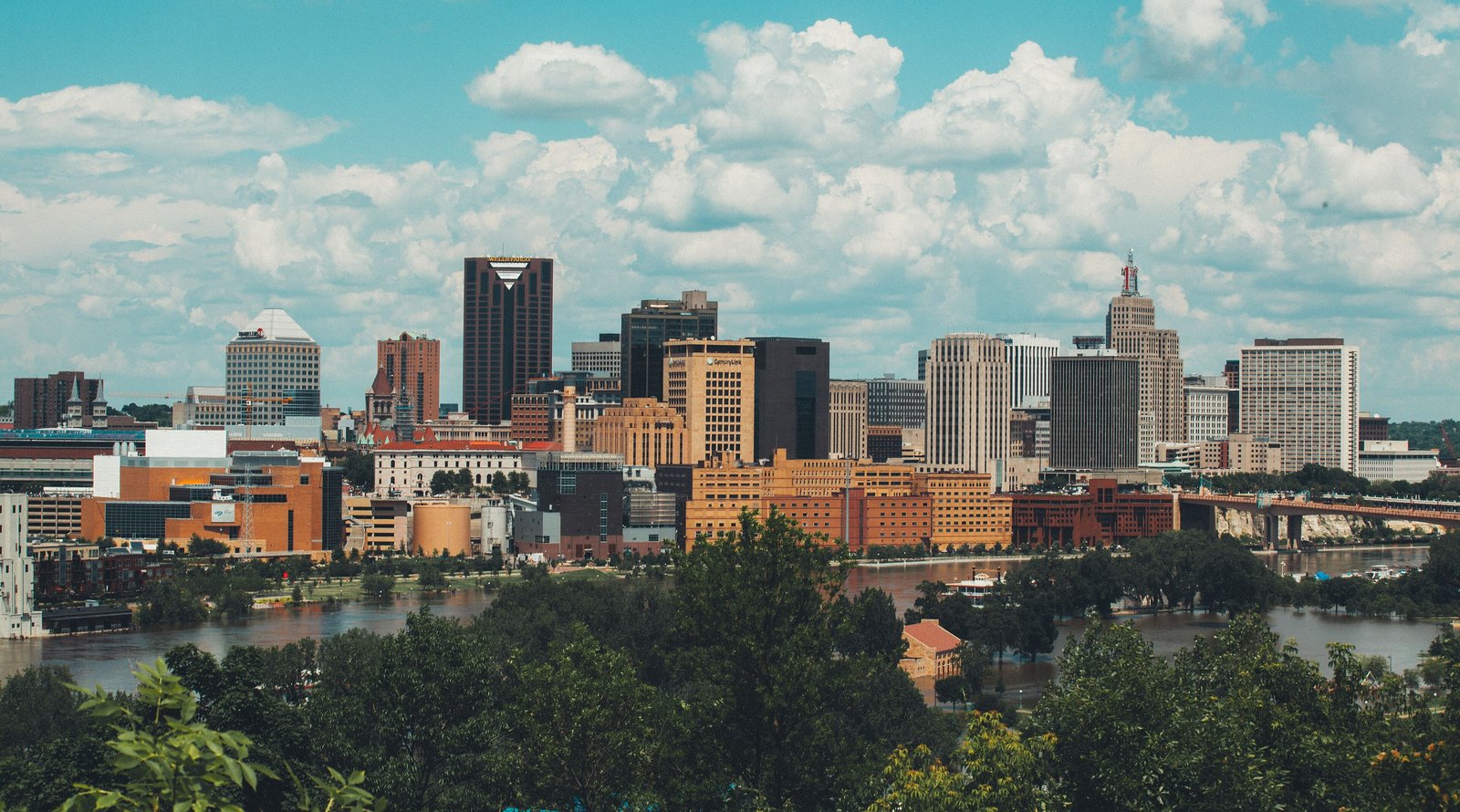 Saint Paul skyline above the Mississippi under summer clouds
