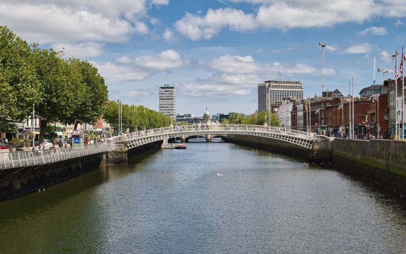 The Ha'penny Bridge over the River Liffey with Dublin quays on a sunny day