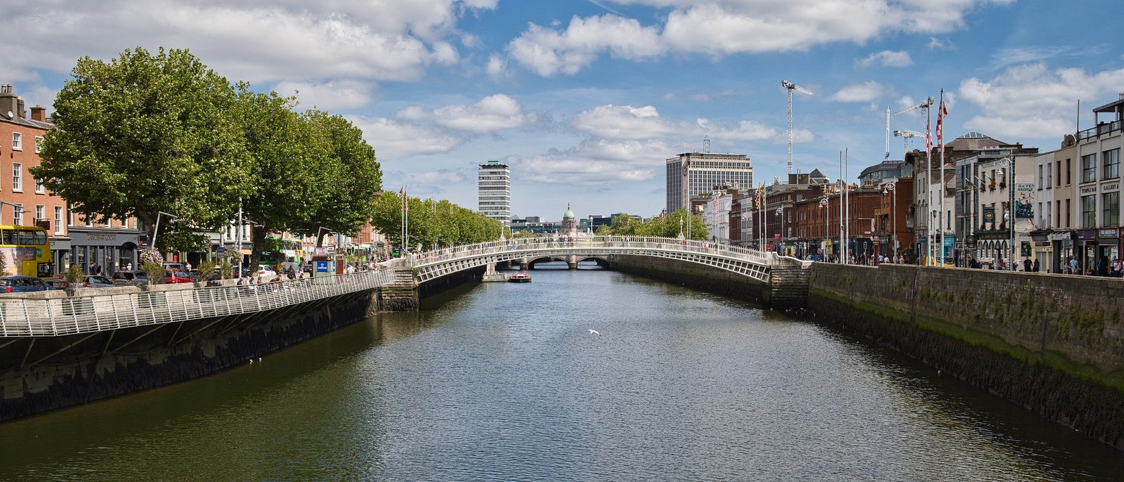 The Ha'penny Bridge over the River Liffey with Dublin quays on a sunny day