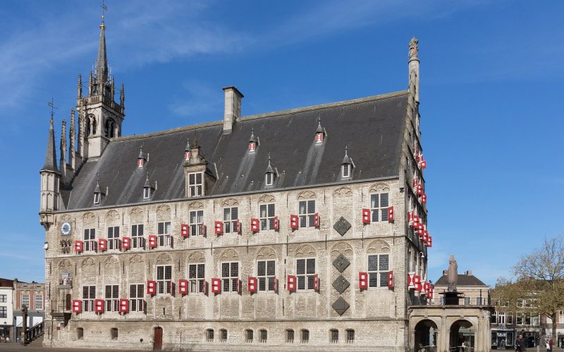 Gouda's Gothic town hall on the market square under a blue sky