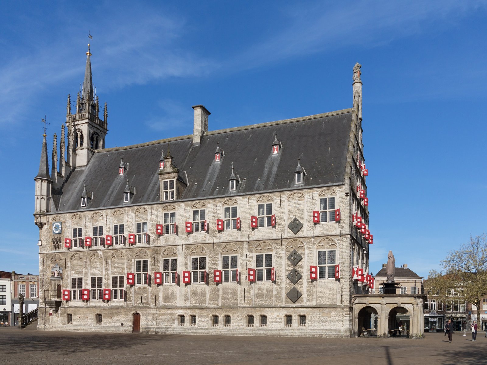 Gouda's Gothic town hall on the market square under a blue sky
