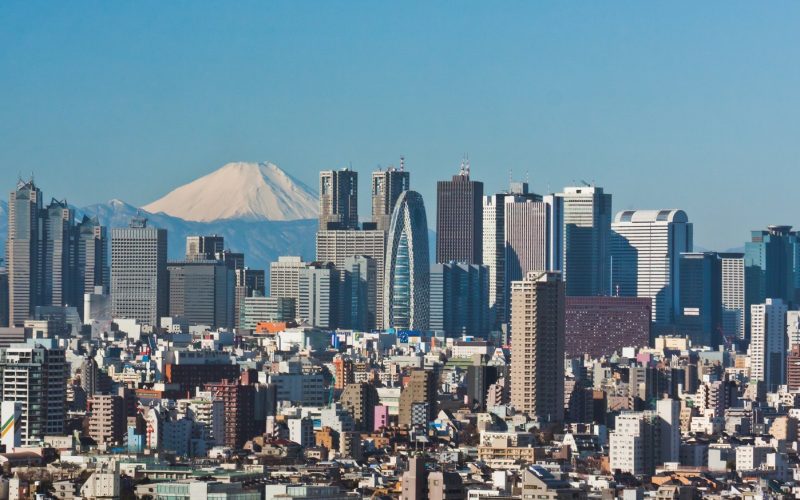 Shinjuku skyscrapers in Tokyo with snow-capped Mount Fuji behind