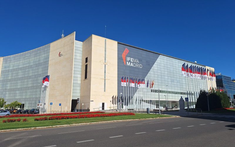 IFEMA Madrid exhibition centre facade under a clear blue sky