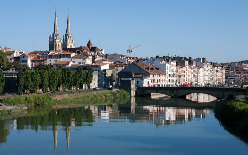 Bayonne cathedral spires and riverside houses reflected in the Nive