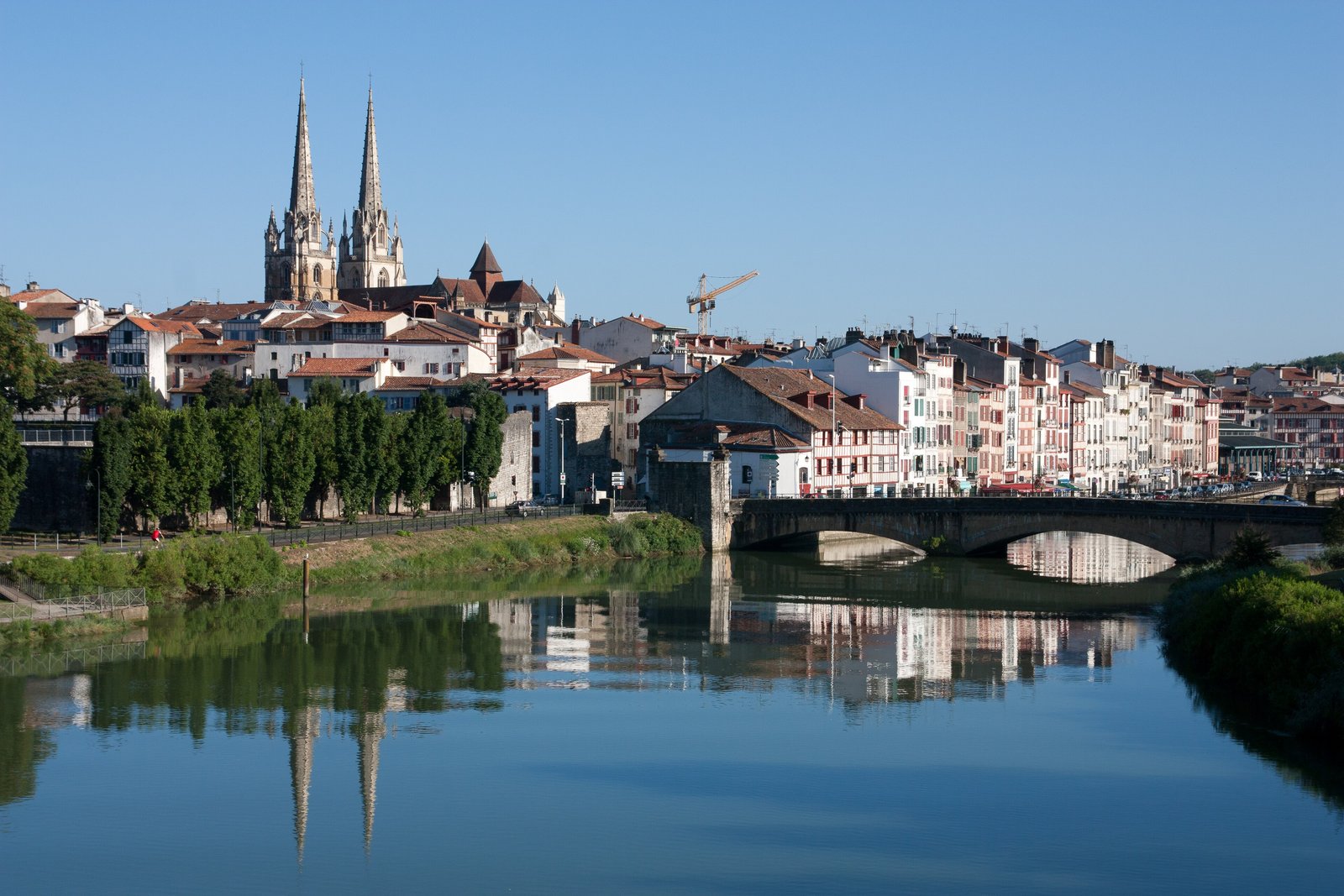 Bayonne cathedral spires and riverside houses reflected in the Nive