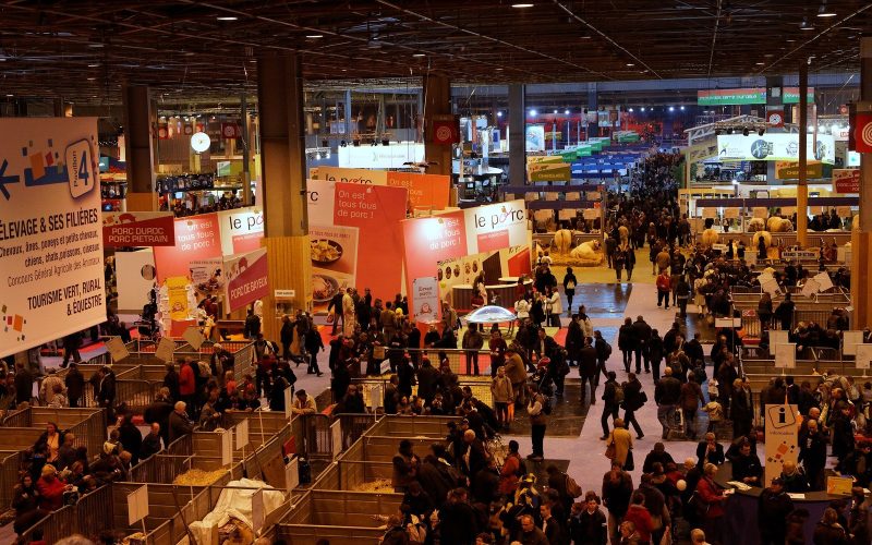 Overview of the crowded exhibition hall at the Salon international de l'agriculture in Paris