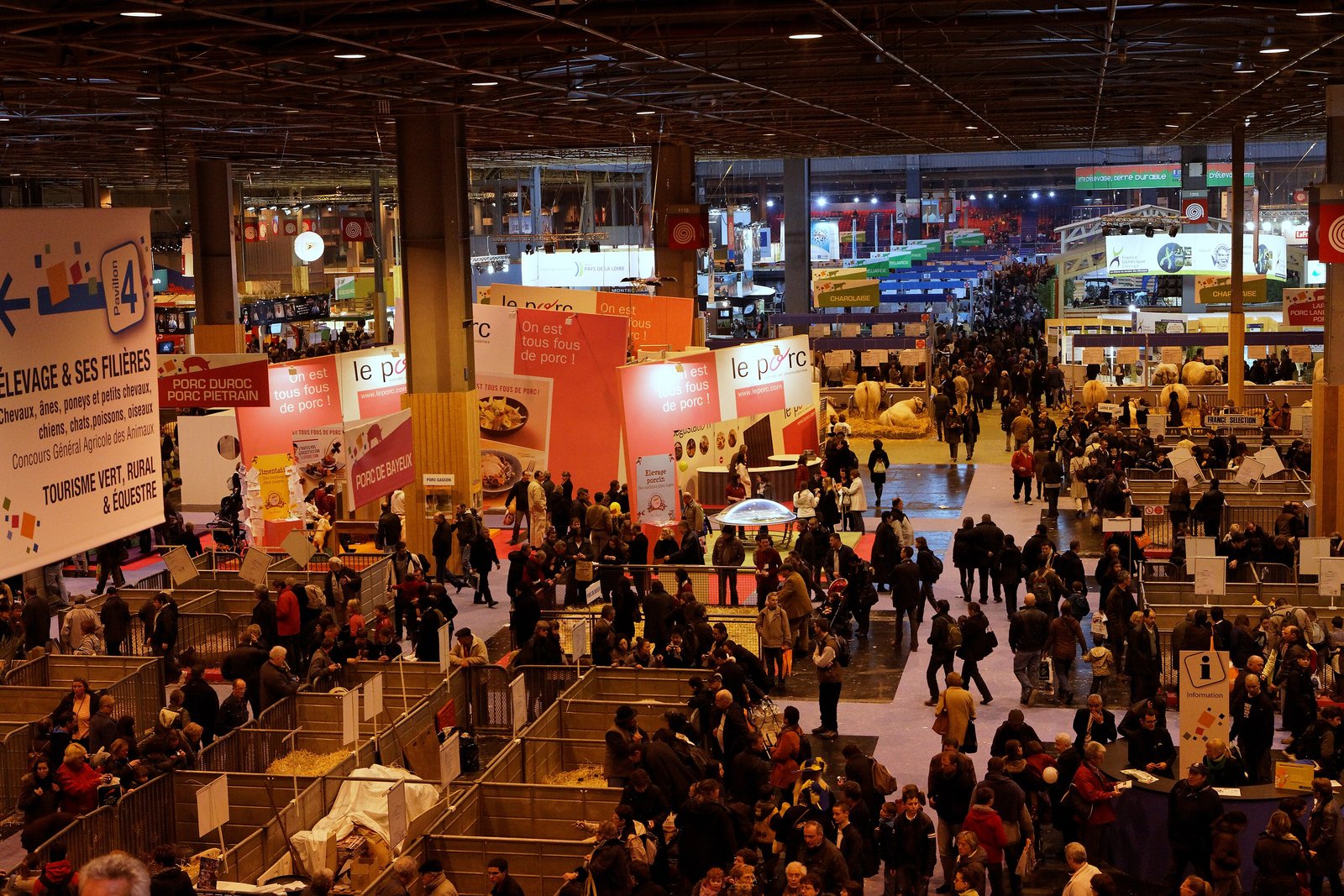 Overview of the crowded exhibition hall at the Salon international de l'agriculture in Paris